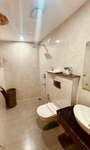 a bathroom with a toilet and a sink at The Rivanta Hotel Near Airport Road Mohali Zirakpur Chandigarh in Zirakpur +33 photos