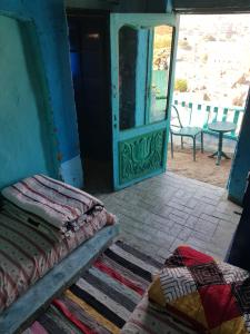 a room with a bed and an open door at Seheil Antique House in Jazīrat Salūjah