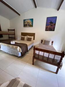 a bedroom with two beds in a room at Vale do Pontal Angra Suites in Angra dos Reis +110 photos