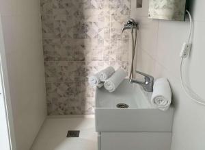 een badkamer met een wastafel en een douche met handdoeken bij Estudio cerca de la playa y del centro de conil in Conil de la Frontera