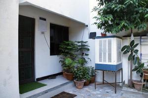 a house with potted plants in front of a door at Men-only COZYCORNER in Lucknow