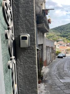 a door of a building with a mailbox on a street at Affitta Camere La Classica in Castiglione di Sicilia