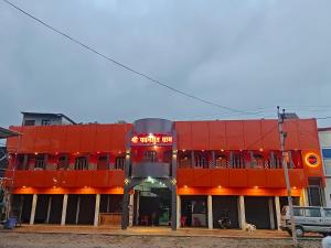a red building with a sign in front of it at Pawansut Dham in Naimishāranya