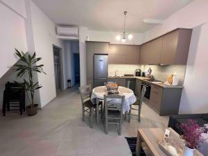 a kitchen and living room with a table and chairs at Eftyhia's Cozy apartment Patmos in Skala