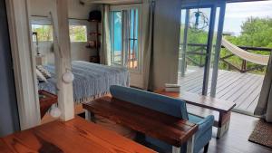 a bedroom with a bed and a table and a balcony at Marasaias in La Pedrera