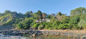 a house on the side of a hill next to a river at Pebble Lanta - Seaview Stay in Ko Lanta