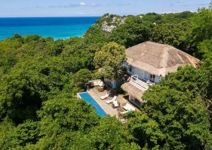 an aerial view of a house with a thatch roof at Spectacular view overlooking the famous Boracay white beach ! in Boracay