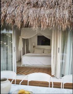 a bedroom with a bed and a straw roof at Spectacular view overlooking the famous Boracay white beach ! in Boracay