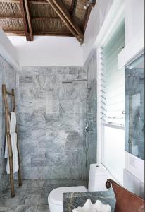 a bathroom with a toilet and a glass shower at Spectacular view overlooking the famous Boracay white beach ! in Boracay