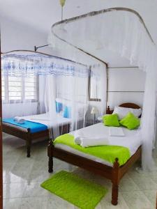 Ένα ή περισσότερα κρεβάτια σε δωμάτιο στο Precious Furaha Homes