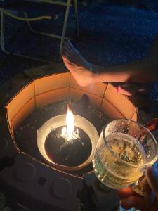 a person holding a candle in a fire pit at บ้านเพื่อนโฮมสเตย์ เขาพนม 