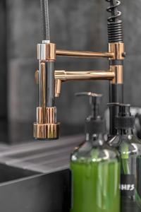 a close up of a sink with two soap bottles at Artrock Experience Loft Gallery in Ermoupoli