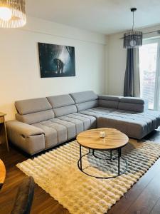 a living room with a couch and a coffee table at Zilina Sweet Escape in Žilina