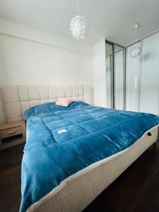 a bed with a blue blanket on top of it at Zilina Sweet Escape in Žilina