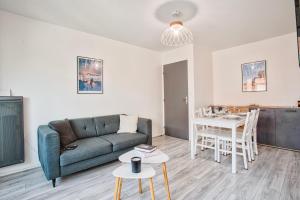 a living room with a couch and a table at 2 Bedrooms, TV & Wifi in Villers-sur-Mer