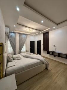 a bedroom with a large bed in a room at Quantum Havens Apartment - Amsterdam in Akure