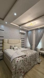 a bedroom with a large bed in a room at Quantum Havens Apartment - Amsterdam in Akure