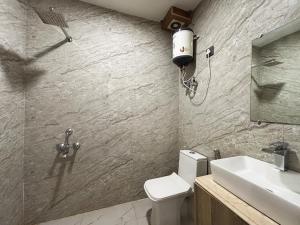 a bathroom with a toilet and a sink at Hotel Lotus Arc NEAR IGI AIRPORT in New Delhi +55 photos