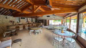a room with tables and chairs in a building at Les Hauteurs du Luberon in Caseneuve