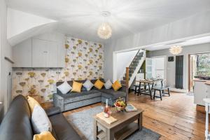 a living room with a couch and a table at The Quirk & Timber Retreat with Free parking in Brighton & Hove