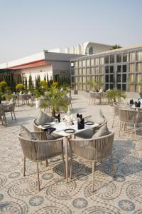 a patio with tables and chairs and a building at JBM resort & hotel in Jāmb