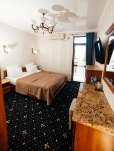 a hotel room with a bed and a sink at Hotel Afrodita in Truskavets