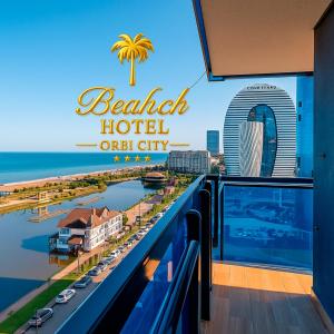 a hotel sign with a view of the ocean at Beach Hotel Orbi City in Batumi