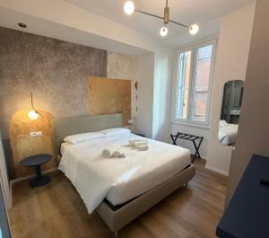 a bedroom with a bed with towels on it at Maison Rasella Suites in Rome