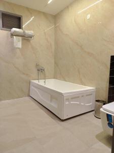 a bathroom with a bath tub in a room at JBM resort & hotel in Jāmb +14 photos