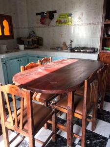 a wooden table and chairs in a kitchen at LoveWave House in Agadir +18 photos