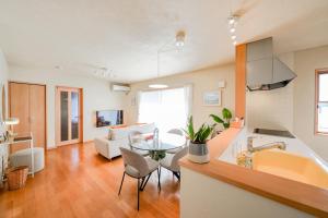 a kitchen and living room with a tub and a table at Peaceful Garden Home in Ota, Entire 3BR Parking in Ota