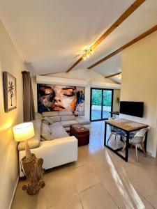 a living room with a couch and a table at La maison des Oiseaux in Trans-en-Provence