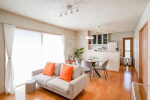 a living room with a couch and a table at Peaceful Garden Home in Ota, Entire 3BR Parking in Ota