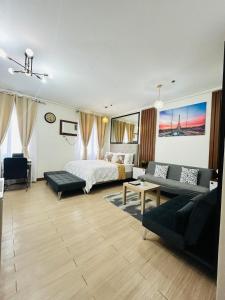 a bedroom with a bed and a living room at Cozy Belle Suite Relaxing Place at SMDC Hope Residences in Trece Martires +27 photos