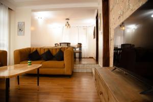 a living room with a couch and a table at Ecolux rebero residence in Kigali