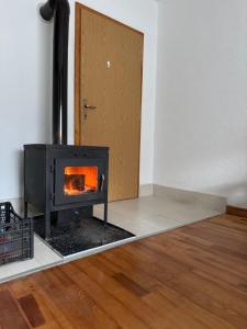 a wood stove in a room with a door at Amaya Home Sarajevo in Vogošća