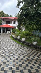 a cobblestone driveway in front of a house with a building at Liya 