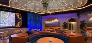 a restaurant with tables and chairs and a ceiling at Harpazul in Catoira