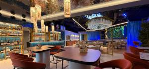 a restaurant with tables and chairs in a room at Harpazul in Catoira