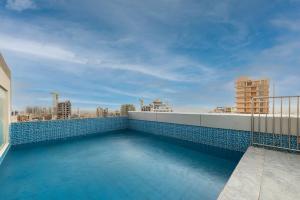 a swimming pool on the roof of a building at Elian Tower AlSahafa Hotel in Riyadh