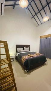 Singon LOMBOK Homestay and Surf في سيلونغ بيلاناك: غرفة نوم فيها سرير و سلم