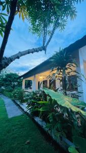 Singon LOMBOK Homestay and Surf في سيلونغ بيلاناك: منزل أمامه الكثير من النباتات