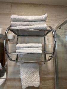 a stack of towels on a towel rack in a bathroom at Villa Srma OHRİD in Ohrid +36 photos