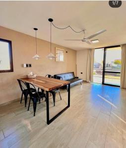 a dining room with a table and a couch at Campo Galano in Miramar