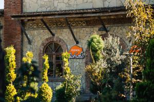 a building with a sign on the front of it at Kera Ethno Hotel in Gvishtibi