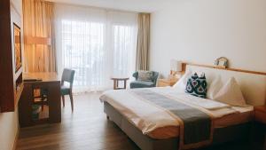 En eller flere senge i et værelse på Hotel Friedheim Weggis