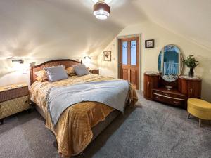 een slaapkamer met een groot bed en een spiegel bij Talltrees - Uk42842 in Uplowman +16 foto's