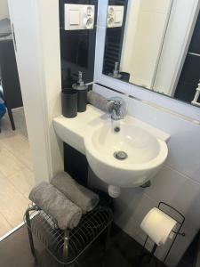 a bathroom with a sink and a mirror and a stool at Komfort Noclegi in Blizne Łaszczyńskiego +24 photos