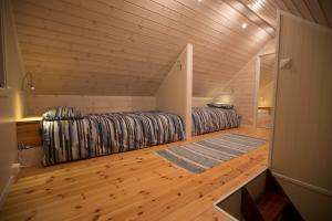 a small room with two beds in a wooden cabin at Vannøy Sport og Havfiske in Vannvåg