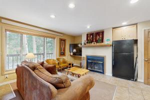 a living room with a couch and a fireplace at On the Rapids - B Unit in Grand Lake